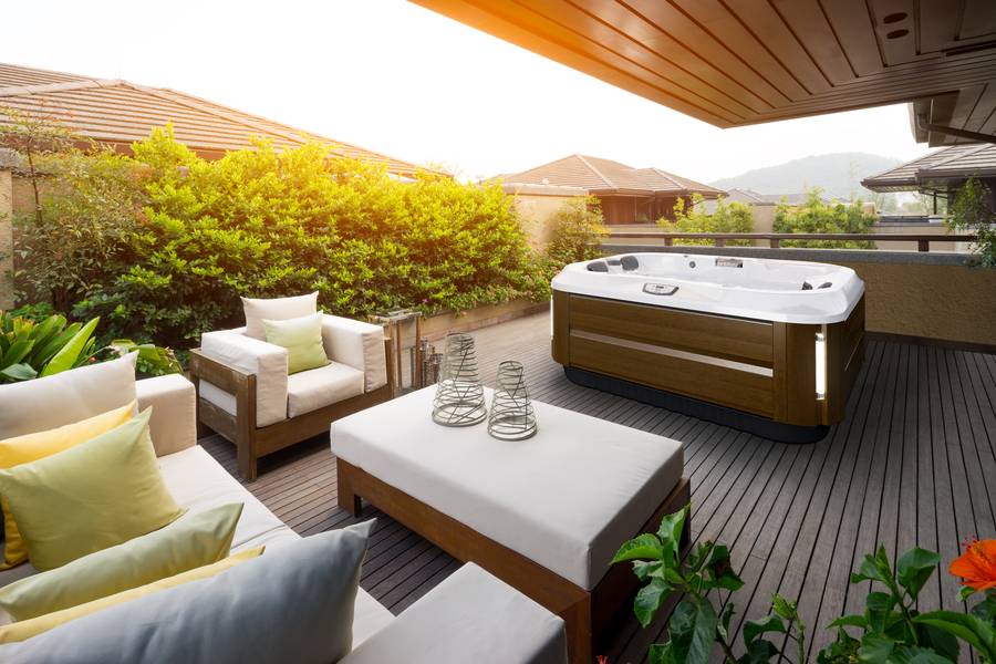 Jacuzzi hot tub under building deck with lounge