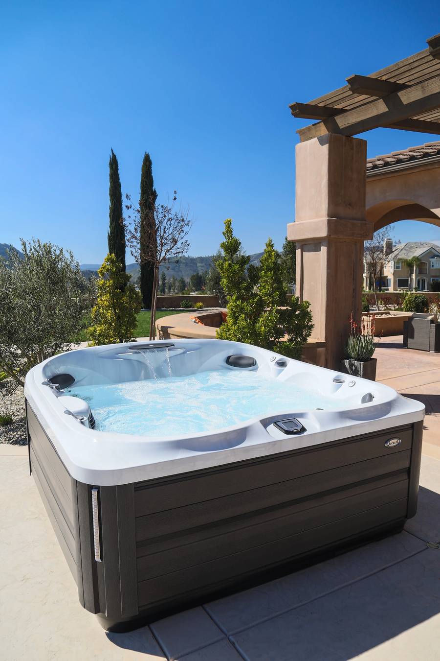 Jacuzzi hot tub waterfall view of backyard